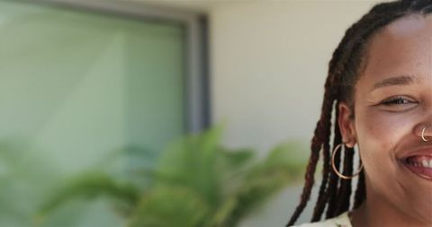 Joyful Woman with Hoop Earrings in Relaxed Home Environment
