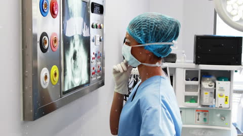 Surgeon Reflecting on X-ray Analysis with Snow Animation Effect