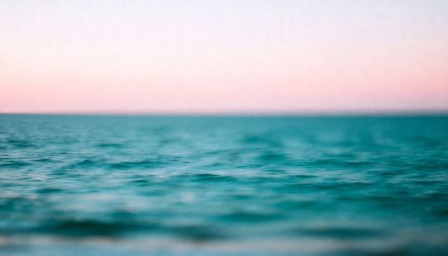 Teal ocean horizon pastel pink sky minimalist calm seascape sunrise open water expanse