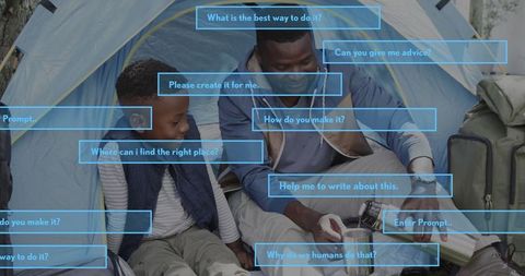 Father and Son Enjoying Campfire Cooking Outdoors in Forest