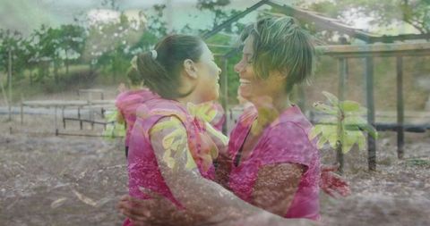 Women hugging and smiling in park interaction indoors