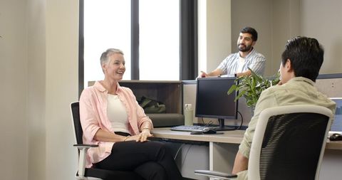 Diverse coworkers engaging in collaborative office discussion