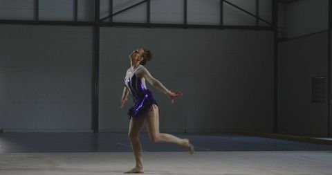 Gymnast in artistic performance indoor sports hall