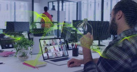 Plaid-shirt man holding mug and lamp joining virtual team meeting with green data overlay