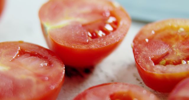 Sliced ripe tomatoes are showcased up close, highlighting their fresh, juicy texture. They are ideal for culinary uses, from salads to sauces, emphasizing healthy eating.