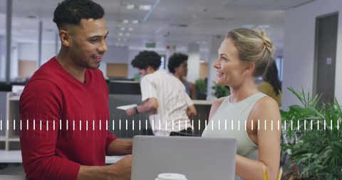 Collaborating Colleagues Engaged in Friendly Office Discussion