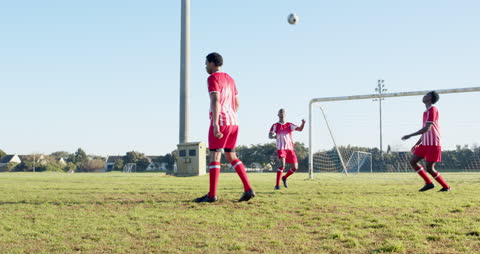 Soccer Players Practicing on Field with Red and White Kits