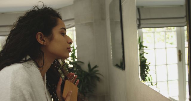 Young Woman With Natural Curls Combing Hair In Bathroom Mirror - Download Free Stock Images Pikwizard.com