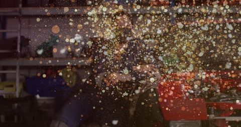 Craftswoman using angle grinder creating vibrant workshop sparks