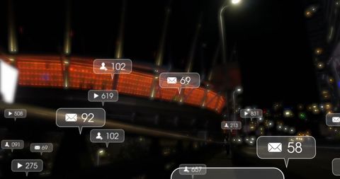 Social media icons over night cityscape illustrating online interactions