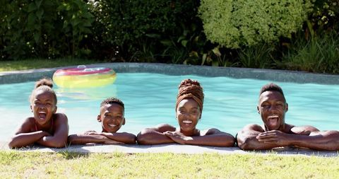 Happy Family Enjoying Summer Pool Time together Relaxing and Smiling