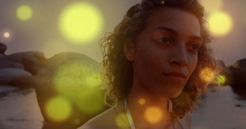 Serene Woman at Sunset Beach with Enchanting Lens Flares