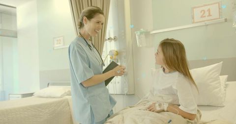 Nurse comforting child patient in hospital bed with IV drip and clipboard