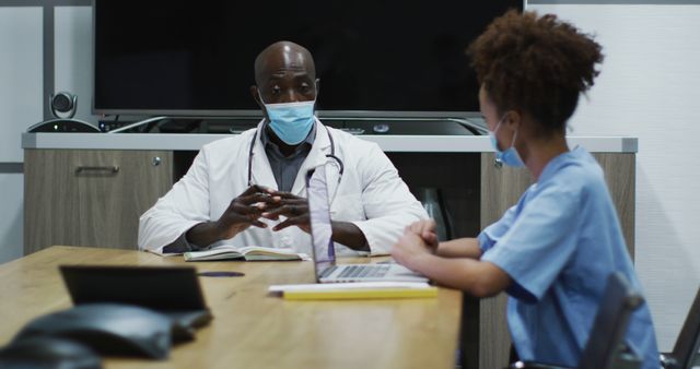 Medical Professionals Wearing Masks Discussing at Conference Table - Download Free Stock Images Pikwizard.com