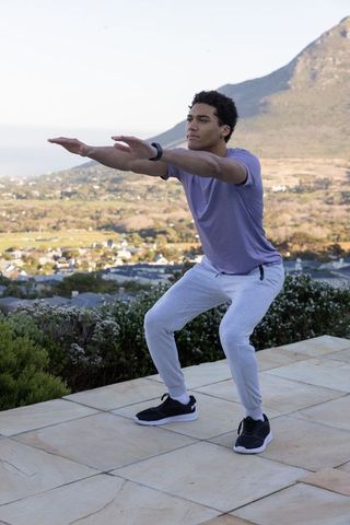 Man Exercising on Outdoor Patio with Scenic Valley View