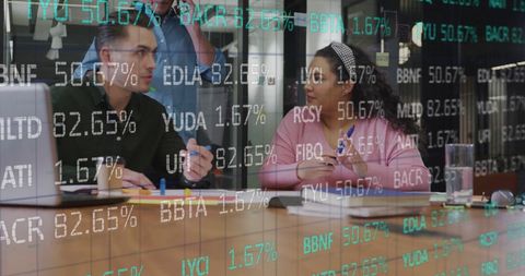 Diverse Colleagues Analyzing Stock Market Trends in Modern Office