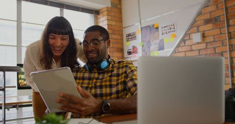 Diverse Creative Team Collaborating on Digital Project in Modern Office