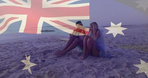 Couple watching pink sunset on australian beach with flag overlay, surfing romance