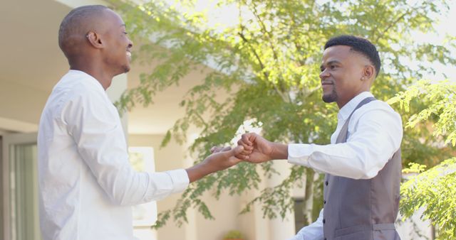 Two Men Celebrating Outdoors with Fist Bump - Download Free Stock Images Pikwizard.com