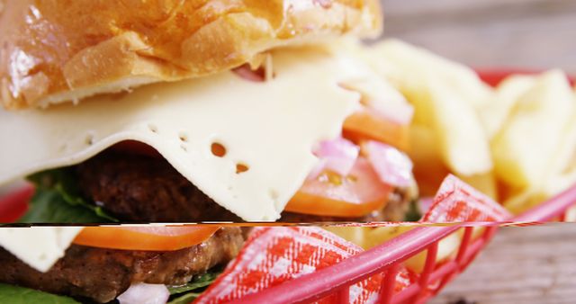 Close-up of a delectable cheeseburger with slices of cheese, tomato, lettuce, and onions in a fluffy bun, accompanied by crispy fries served in a red plastic basket. Perfect image for articles and advertisements focusing on fast food, junk food indulgence, or casual dining experiences. Ideal for use on restaurant menus, food blogs, social media posts, or culinary magazines.
