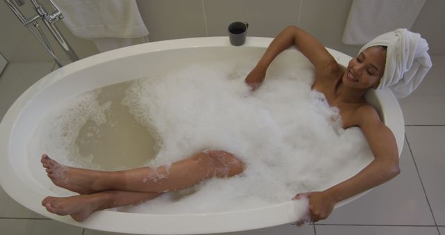 Relaxing Woman Enjoying Bubble Bath with Towel on Head - Download Free Stock Photos Pikwizard.com