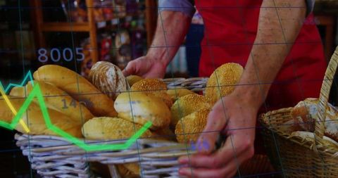 Baker arranging fresh artisan bread in bakery