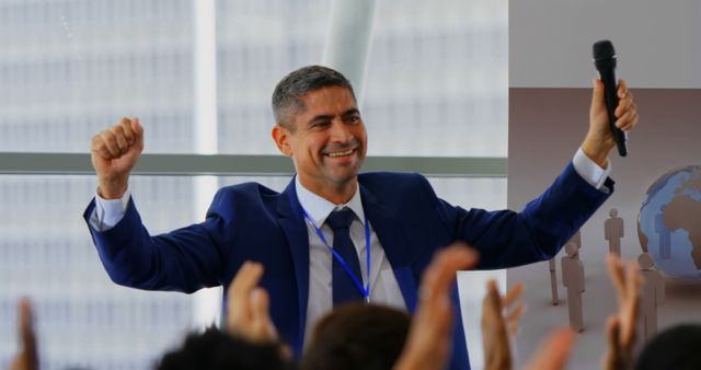 A businessman celebrates success to applause at a seminar in a 4K front view. - Download Free Stock Photos Pikwizard.com