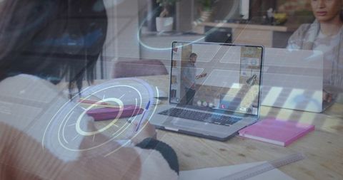 Augmented remote learning student taking notes while viewing laptop presenter with HUD overlay