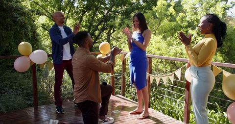 Exciting terrace engagement celebration among friends