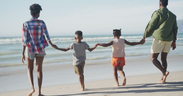 Happy Family Walking on Beach Holding Hands - Download Free Stock Images Pikwizard.com