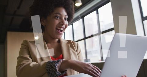 Excited Businesswoman Reacting to Laptop with 'LOL' Overlay