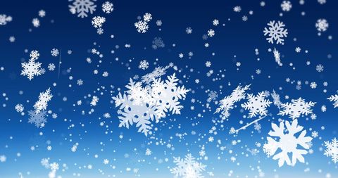 Festive White Snowflakes Falling on Blue Backdrop
