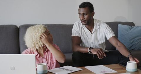 Friends Creating Project Ideas at Home with Laptop and Notebook