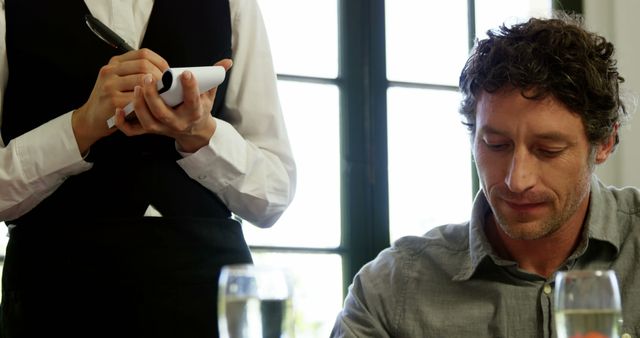 Man Dining in Restaurant Being Served by Waiter - Download Free Stock Images Pikwizard.com