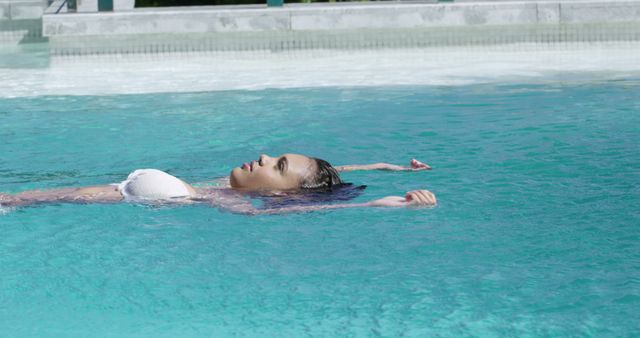 Relaxed Woman Floating in Resort Pool on Summer Day - Download Free Stock Images Pikwizard.com