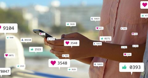 Woman holding smartphone scrolling with social media notifications over seaside railing