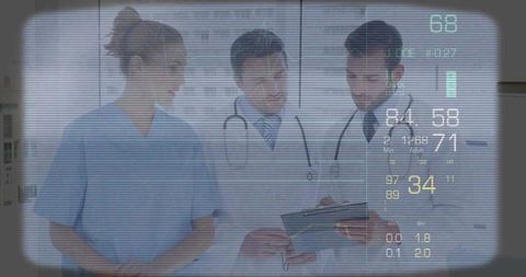Medical team reviewing tablet with futuristic hud vital signs display
