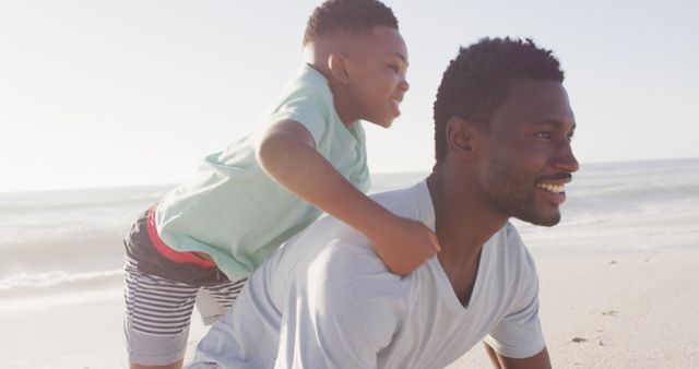 Joyful African American Father and Son Playing on Beach - Download Free Stock Images Pikwizard.com