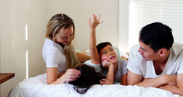 Happy family playing and bonding together in bedroom - Download Free Stock Images Pikwizard.com