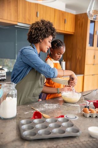 Mother and daughter baking together in cozy culinary setting