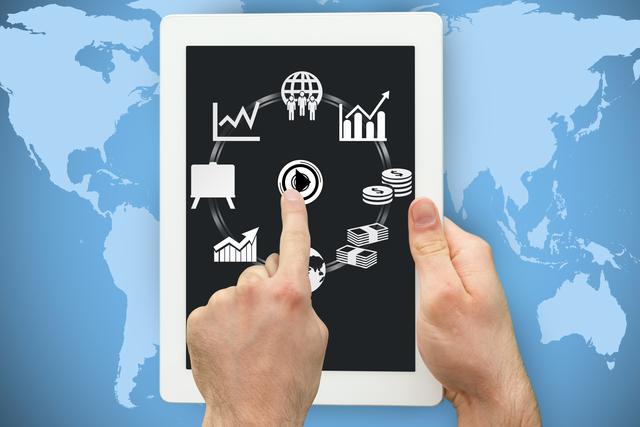 Image shows hands using a tablet computer displaying various financial charts and graphs against a backdrop of a world map. Can be used in contexts such as business presentations, financial analytics, global economy, mobile technology in business, and digital data visualization.