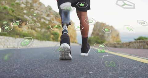 Male runner jogging with carbon prosthetic blade on coastal road showing green ar icons
