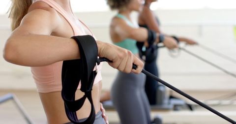 diverse women exercising on pilates reformers in fitness studio - Download Free Stock Images Pikwizard.com