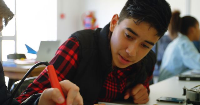 Teen Boy Engaging in STEM Learning Activity in Classroom - Download Free Stock Images Pikwizard.com