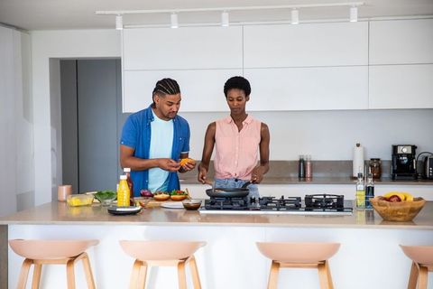 Couple Making Meal Together in Contemporary Kitchen Setting