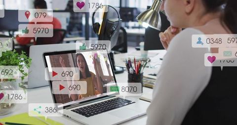 Woman watching live remote presentation on laptop with social media engagement overlays