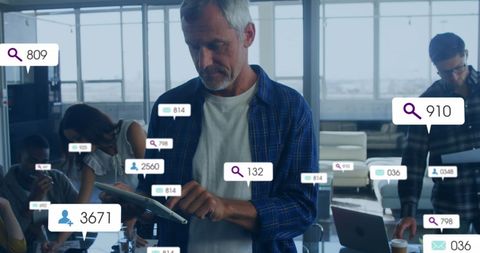 Businessman engaging with digital notification analytics in office