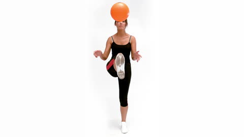Woman Performing Ball Tricks During Workout Session