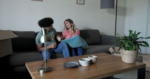 Happy Couple Unpacking and Arranging New Home Living Room