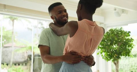 Young couple dancing together enjoying intimate moment at home